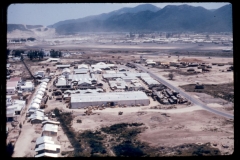 This photograph was taken on the north side of the runway at Nha Trang. In the foreground is the large warehouse which was recently completed by C Co of the 864th Engineer Battalion. This warehouse is being used to store medical supplies and it is located adjacent to the field hospital at Nha Trang.
